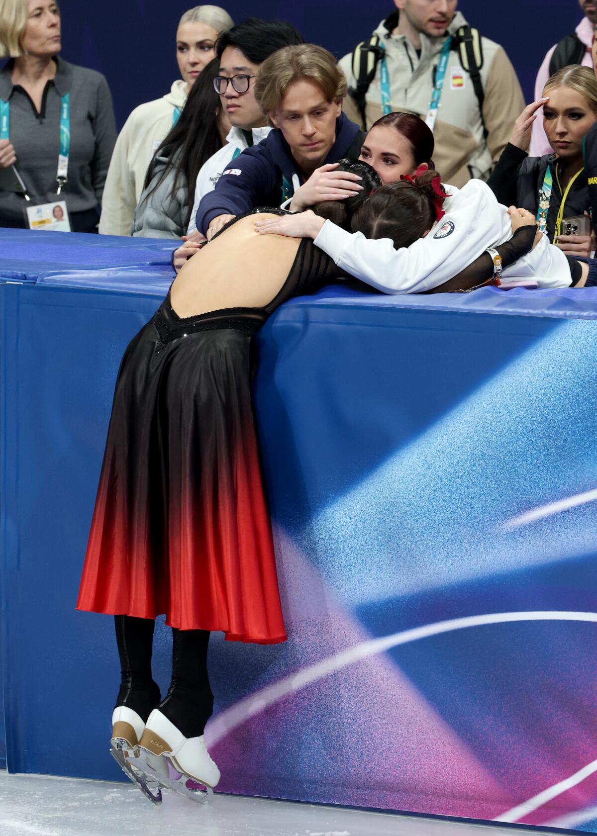 Madison Chock is consoled by friends and family during a silver-medal finish at the Olympic Games on Wednesday.