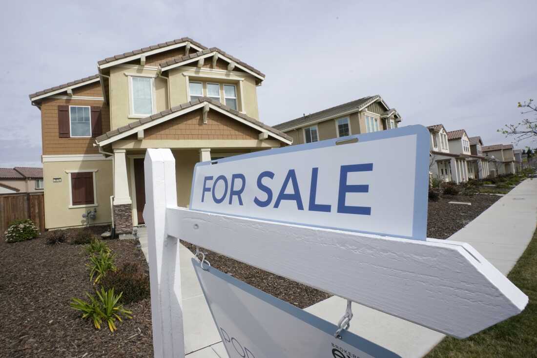 A for sale sign is posted in front of a home in Sacramento, Calif. 