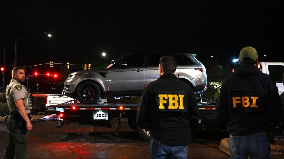 TUCSON, ARIZONA - FEBRUARY 13: FBI agents watch as a vehicle is towed from the parking lot of a restaurant on February 13, 2026 in Tucson, Arizona. The Range Rover SUV was searched and its trunk sealed before it was removed. The vehicle was located close to a neighborhood that law enforcement had sealed off earlier in the evening as the investigation into Nancy Guthrie's disappearance continues. (Photo by Brandon Bell/Getty Images)