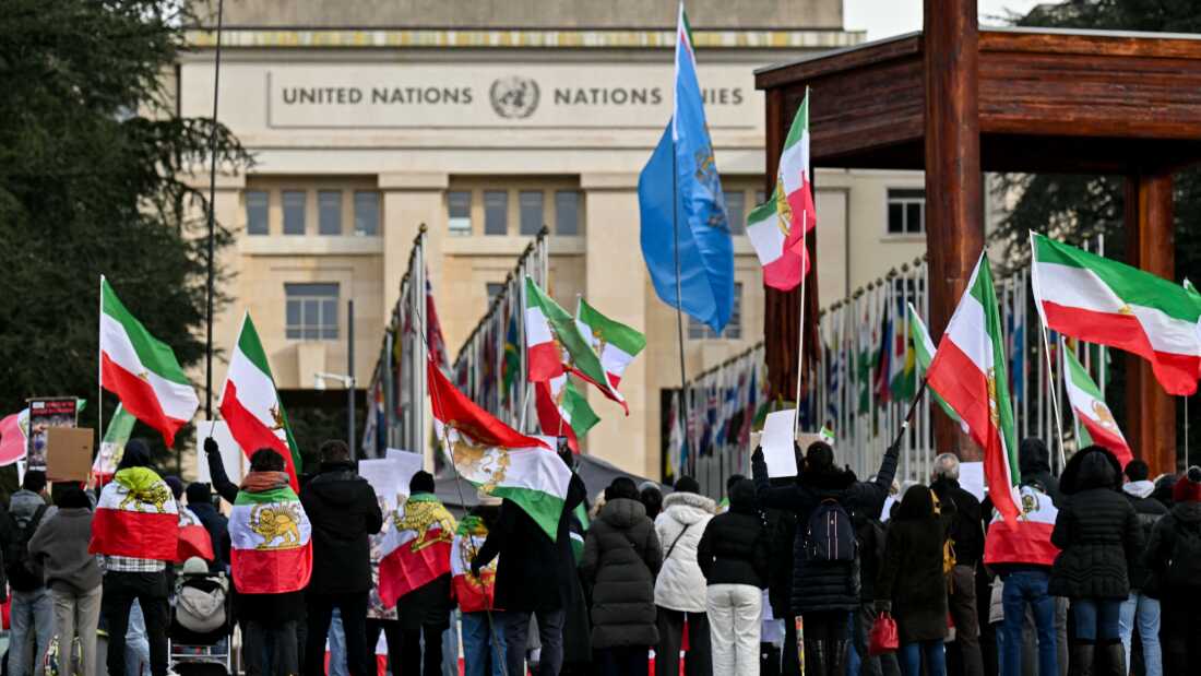 Protesters hold Iranian pre-Islamic revolution of 1979 flags in front of the United Nations office ahead of indirect nuclear talks between the United States and Iran in Geneva on Feb. 17.