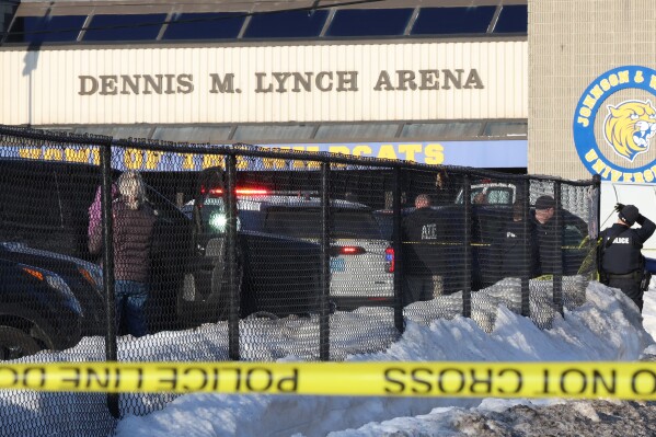 Police and ATF agents stand near the Lynch Arena in Pawtucket, R.I., after a shooting at the ice rink, Monday, Feb. 16, 2026. (AP Photo/Mark Stockwell)