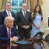 President Trump is pictured at the Resolute Desk with OMB Director Russell Vought, Homeland Security Sec. Kristi Noem and Interior Sec. Doug Burgum standing behind him. 