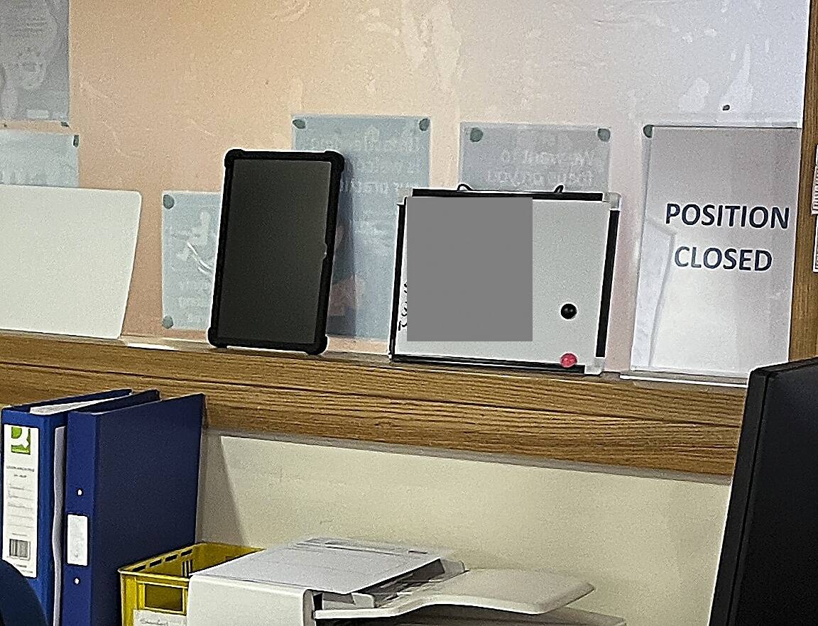 Whiteboard showing confidential information (obscured)