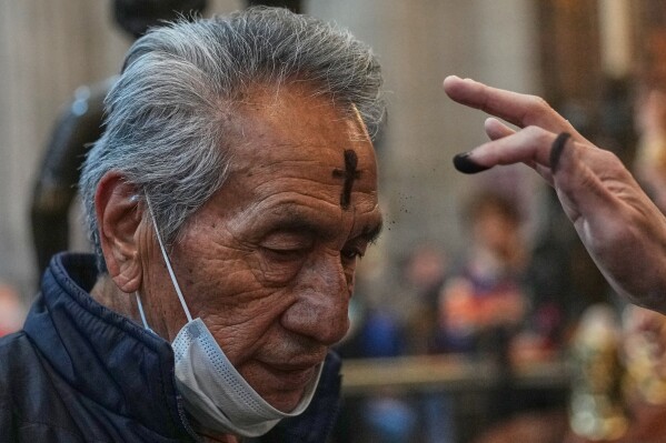 A parishioner receives ashes on Ash Wednesday in Mexico City, Feb. 18, 2026. (AP Photo/Marco Ugarte, File)