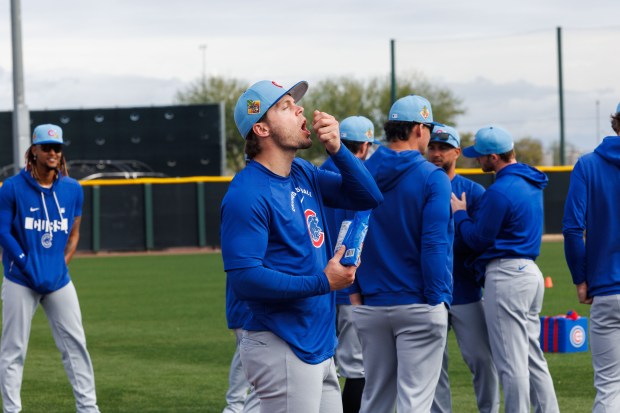 Cubs second baseman Nico Hoerner eats sunflower seeds before warming up at spring training on Feb. 18, 2026, at Sloan Park in Mesa, Ariz. (Armando L. Sanchez/Chicago Tribune)