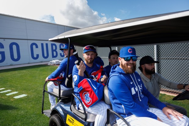 Nico Hoerner, Dansby Swanson, Michael Busch, and Alex Bregman ride a golf cart during spring training at Sloan Park on Tuesday, Feb. 17, 2026, in Mesa, Ariz. (Armando L. Sanchez/Chicago Tribune)
