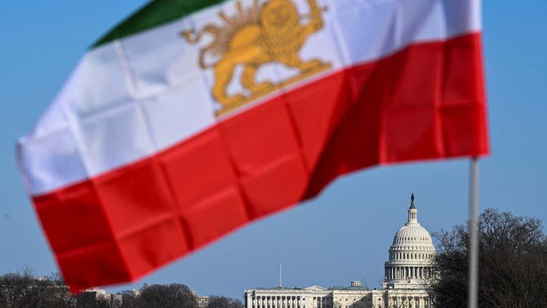The Iranian pre-Islamic revolution of 1979 flag is seen near the U.S. Capitol during a march in support of the people of Iran by members of the American-Iranian community in Washington, D.C.