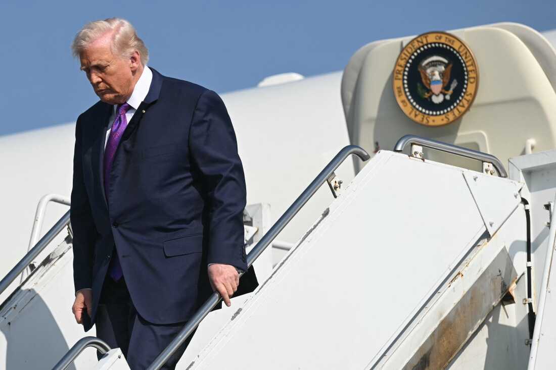 President Trump descends the steps outside Air Force One upon arrival in Rome, Georgia, on February 19.