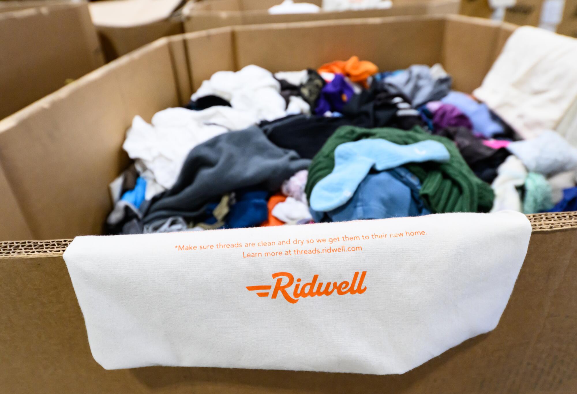 Wearable fabrics are seen in boxes and bins awaiting transport