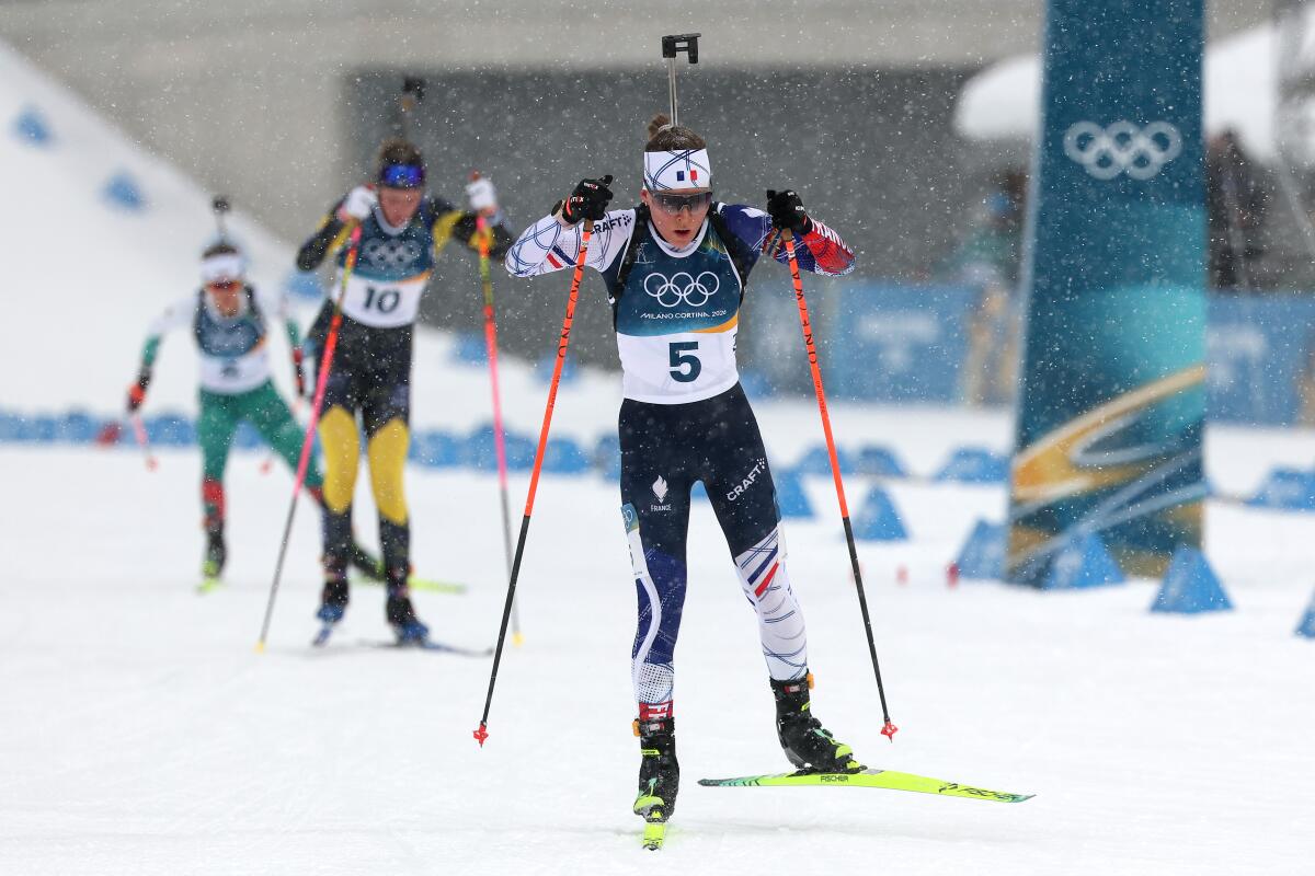 Oceane Michelon of France approaches the finish line to win gold in the women's 12.5-kilometer biathlon mass start.