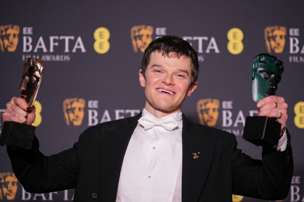 Robert Aramayo poses with the EE rising star award and the award for leading actor for 'I Swear' at the 79th British Academy Film Awards, BAFTA's, in London, Sunday, Feb. 22, 2026. (AP Photo/Alastair Grant)
