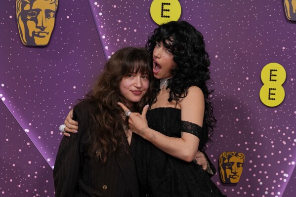 Gideon Adlon, left, and Odessa A'zion pose for photographers upon arrival at the 79th British Academy Film Awards, BAFTA's, in London, Sunday, Feb. 22, 2026. (AP Photo/Alastair Grant)