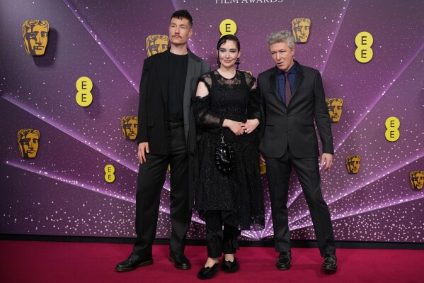 Dan Smith, from left, Kathryn Ferguson and Aidan Gillen pose for photographers upon arrival at the 79th British Academy Film Awards, BAFTA's, in London, Sunday, Feb. 22, 2026. (AP Photo/Alastair Grant)