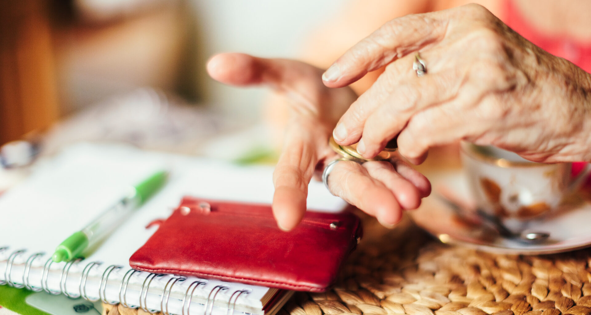 Senior woman calculating finances in her kitchen.