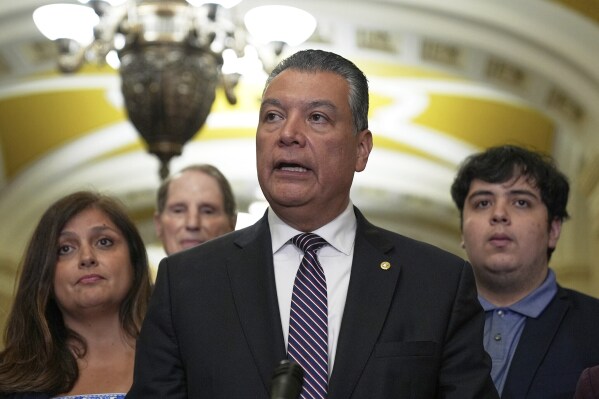 FILE - Sen. Alex Padilla, D-Calif., center, talks at a news conference after a policy luncheon on Capitol Hill, June. 17, 2025, in Washington. (AP Photo/Mariam Zuhaib)