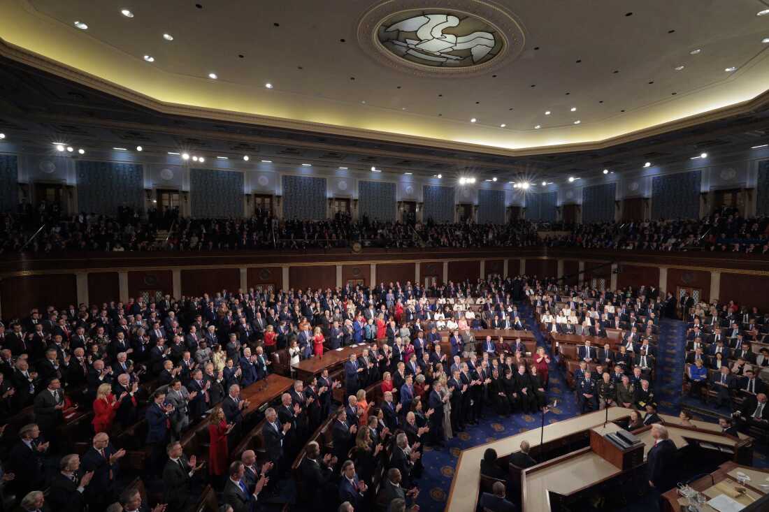 President Donald Trump stands in front of Congress members inside the Capitol.