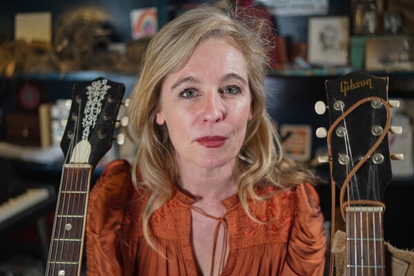 Singer and songwriter Tift Merritt, co-chair of the Artist Rights Alliance, poses for a photo with her guitars at her home in Raleigh, N.C., Thursday, Jan. 29, 2026. (AP Photo/Allen G. Breed)