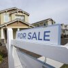 A for sale sign is posted in front of a home in Sacramento, Calif. 