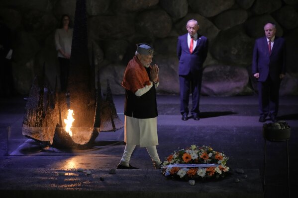 India's Prime Minister Narendra Modi lays a wreath and a rock at the Hall of Remembrance during his visit to the Yad Vashem Holocaust Memorial Museum in Jerusalem, Thursday, Feb. 26, 2026. (AP Photo/Leo Correa)