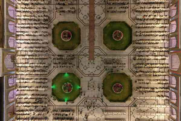 Photographed from high above, Shiites break their fast during the Islamic holy month of Ramadan in the Imam Ali shrine in Najaf, Iraq, Thursday, Feb. 26, 2026. (AP Photo/Anmar Khalil)