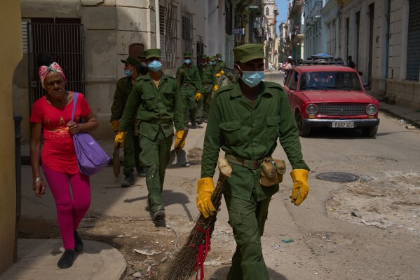 Soldiers walk through Old Havana to collect garbage in Havana, Cuba, Thursday, Feb. 26, 2026. (AP Photo/Ramon Espinosa)