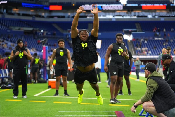 Texas A&M defensive lineman Tyler Onyedim (23) runs a drill at the NFL football scouting combine in Indianapolis, Thursday, Feb. 26, 2026. (AP Photo/Julio Cortez)