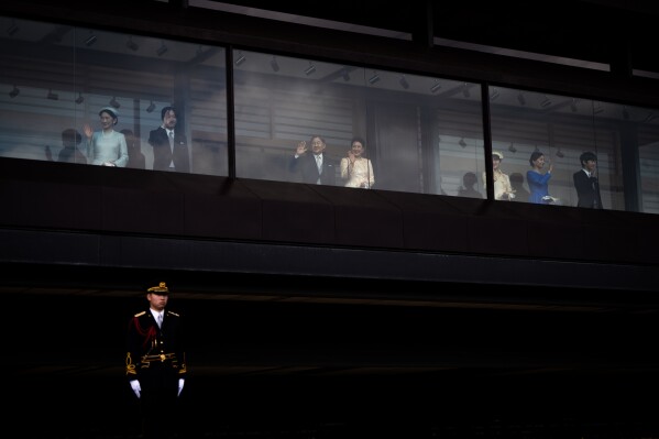 Japan's Emperor Naruhito and Empress Masako, center, along with other members of the imperial family, wave to well-wishers from a balcony during a public appearance marking the emperor's 66th birthday at the Imperial Palace in Tokyo, Feb. 23, 2026. (AP Photo/Louise Delmotte, File)