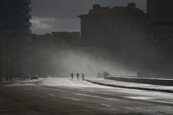 People walk along the Malecón in Havana, Feb. 23, 2026. (AP Photo/Ramon Espinosa, File)