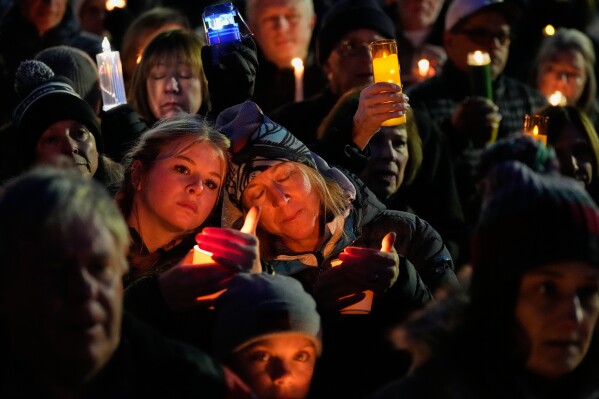 People observe a moment of silence during a vigil for the nine people who died in an avalanche in California's Sierra Nevada, in Truckee, Calif., Feb. 22, 2026. (AP Photo/Godofredo A. Vásquez, File)