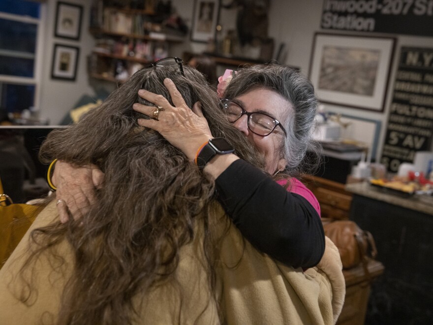 Las Comadres Para Las Americas potluck monthly gathering in Austin, Texas on Jan. 27. Nora de Hoyos Comstock, Las Comadres founder, greets a member.