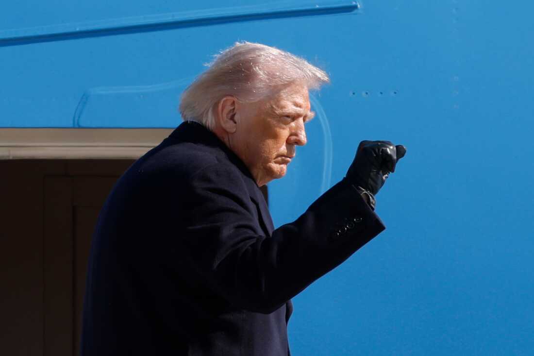 President Donald Trump gestures from the stairs of Air Force One upon his arrival at Joint Base Andrews, Md., Friday, Feb. 27, 2025.