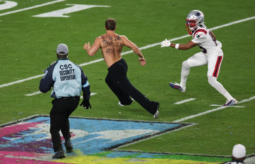 New England Patriots wide receiver Kyle Williams and a security supervisor pursuing a streaker on a football field.