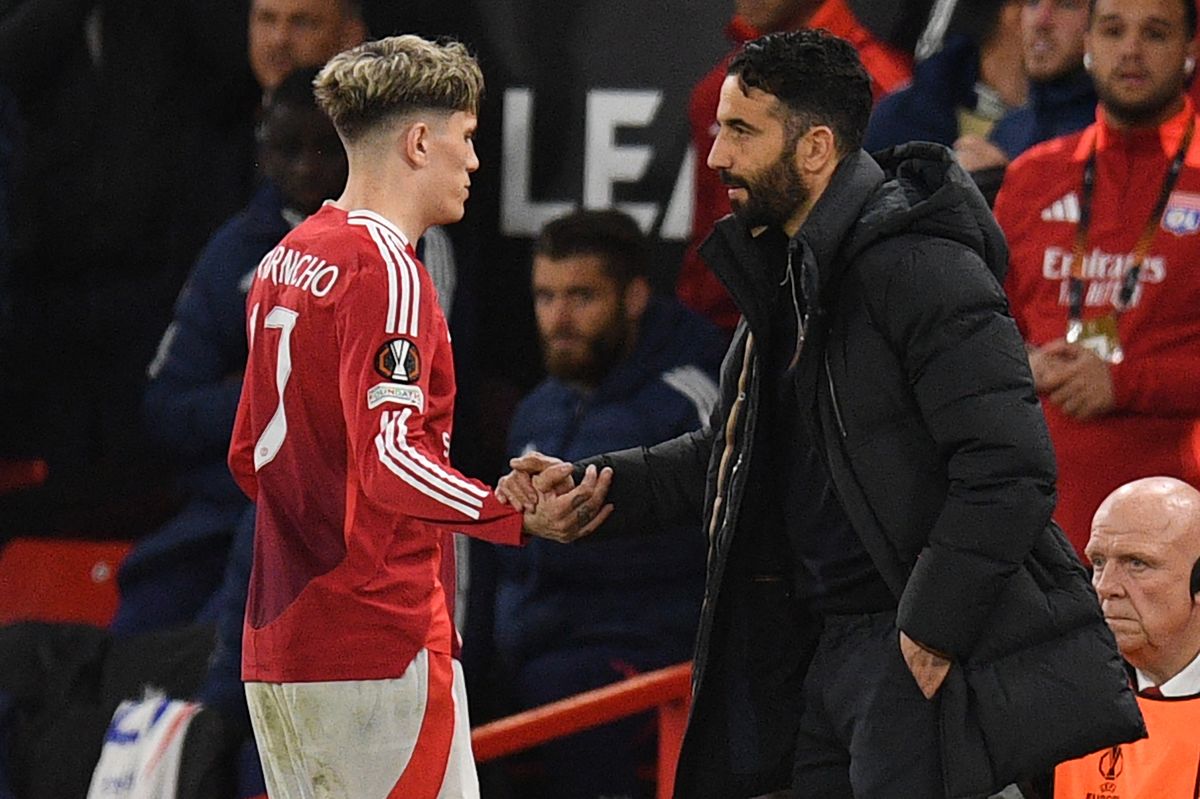 Manchester United's Portuguese head coach Ruben Amorim (R) shakes hands with Manchester United's Argentinian midfielder #17 Alejandro Garnacho (L) as he leaves the game, substituted during the UEFA Europa league quarter-final final, second leg football match between Manchester United and Lyon