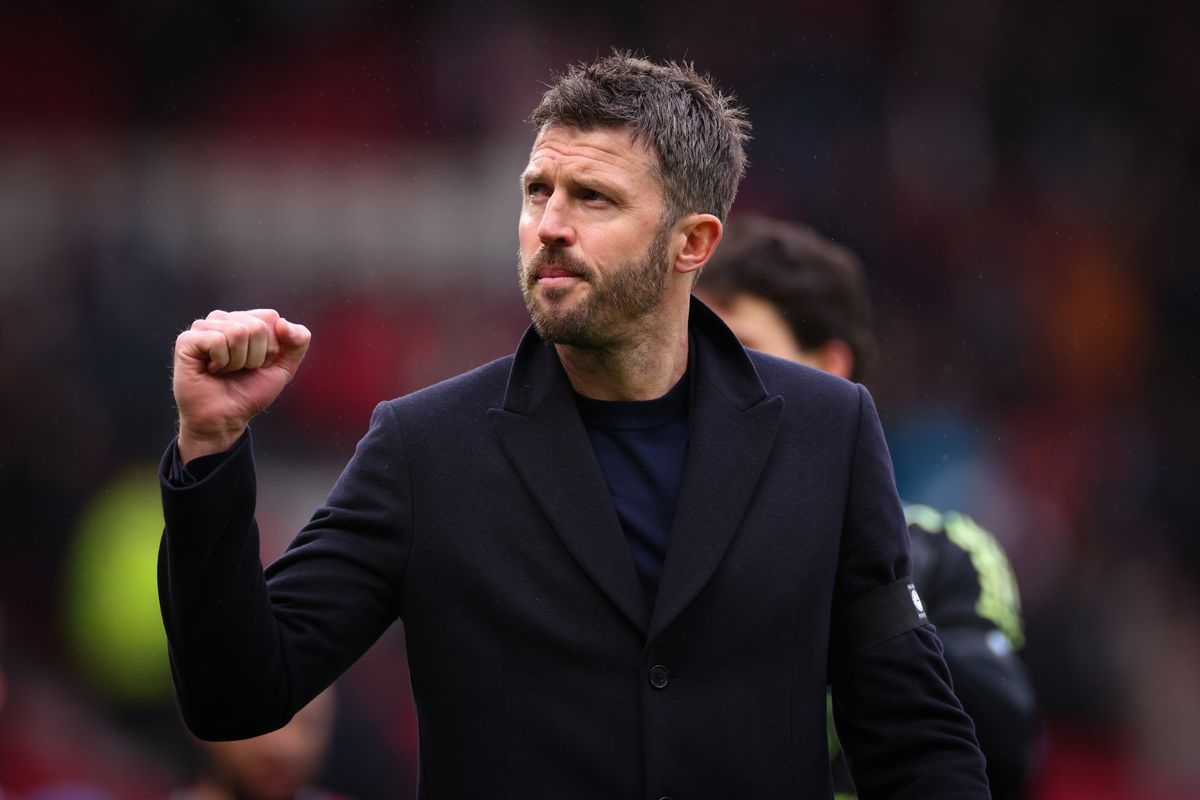 Michael Carrick gestures at fans