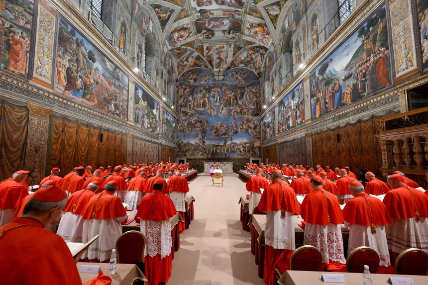 Pope Leo XIV stands in the Sistine Chapel among cardinals after being elected in May last year.