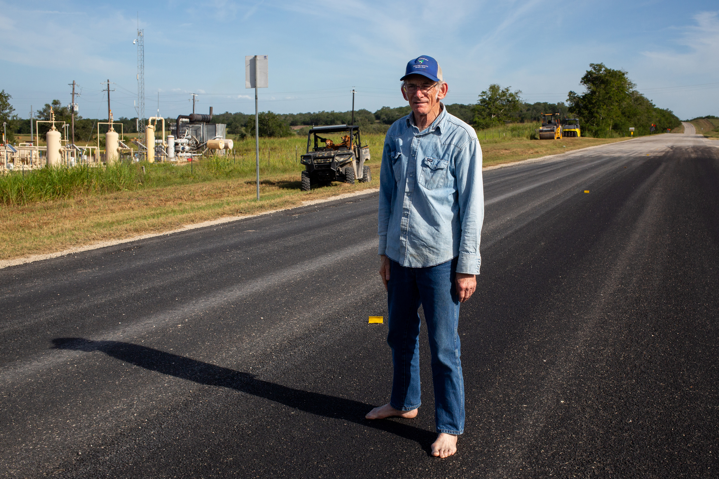 Blake Muir stands on FM 766 in Gonzales County near the waterline of the October 1998 flood. Credit: Dylan Baddour/Inside Climate News