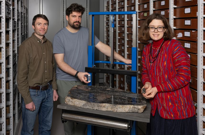 From right, researchers Sandy Hetherington, Corentin Loron and Laura Cooper, who led the new study, at the Museum of Scotland's National Museums Collection Centre with some Prototaxites fossils.