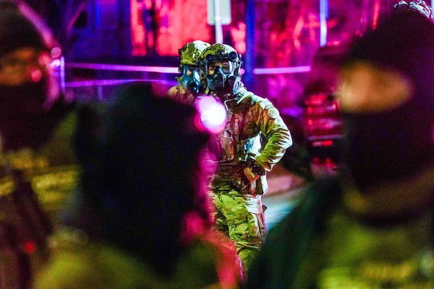 Federal agents stand in Minneapolis, Minnesota, where protests have unfolded following the fatal shooting of Renee Good. Ring users' privacy and safety concerns coincided with these nationwide protests.