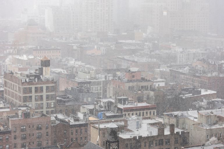 Snow covers residential buildings during a winter storm in the Brooklyn Borough
