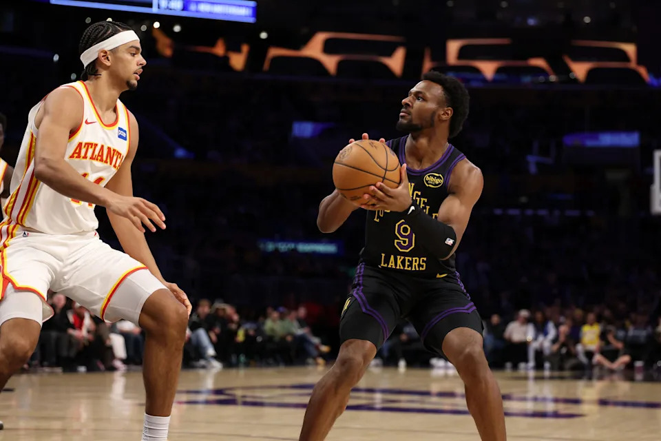 Jan 13, 2026; Los Angeles, California, USA; Los Angeles Lakers guard Bronny James (9) looks to shoot the ball against Atlanta Hawks forward Asa Newell (14) during the second half at Crypto.com Arena. Mandatory Credit: Kiyoshi Mio-Imagn Images
