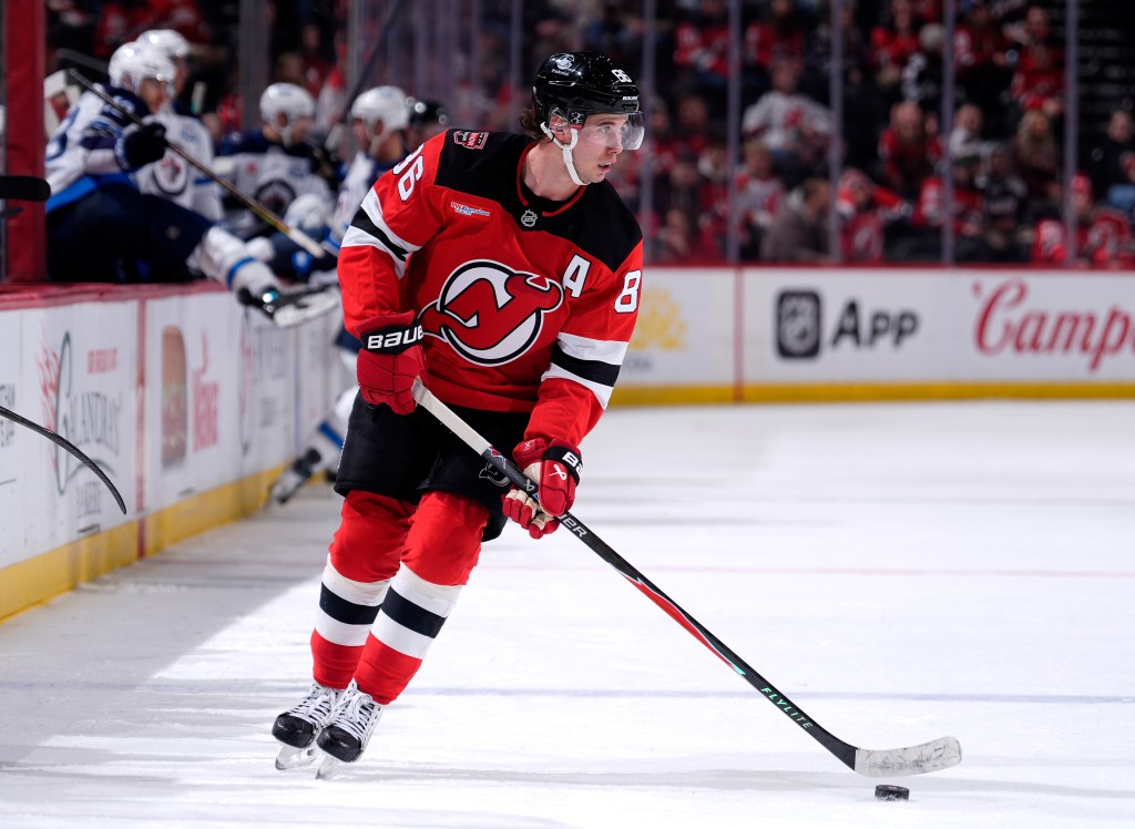 Jack Hughes #86 of the New Jersey Devils takes the puck during the third period against the Winnipeg Jets at Prudential Center on January 27, 2026 in Newark, New Jersey.