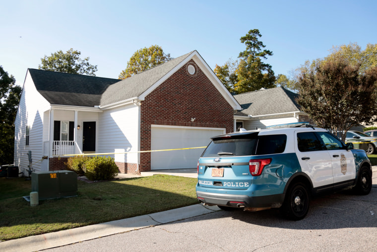 A Raleigh police car parked outside of a home