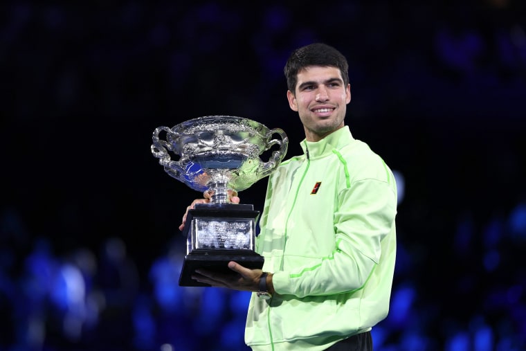 Spain's Carlos Alcaraz poses with the Norman Brookes Challenge Cup after defeating Serbia's Novak Djokovic 