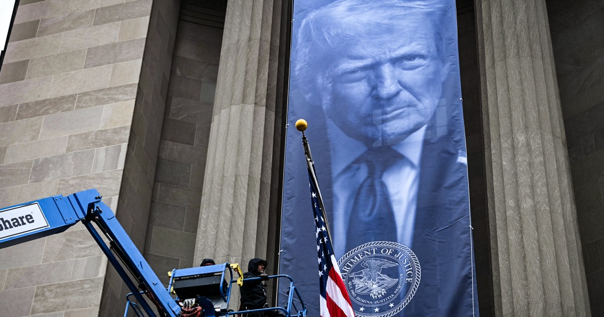 Large banner of Trump unfurled at Justice Department headquarters