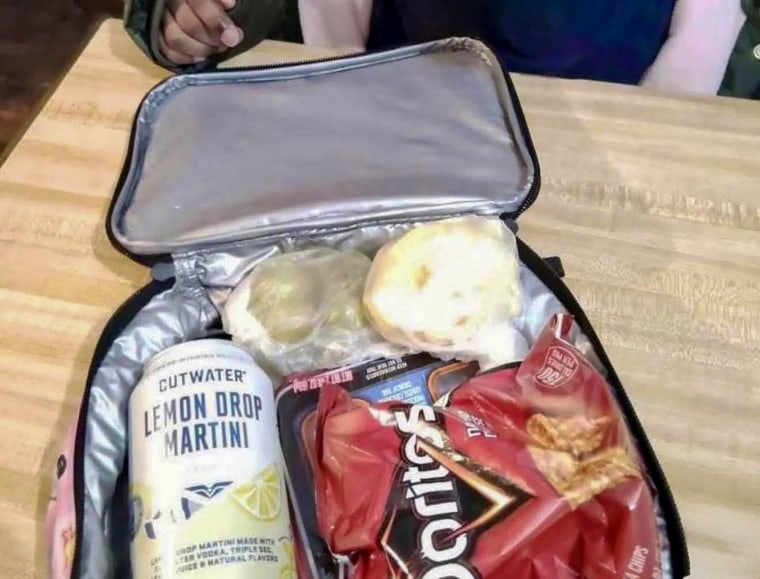 A photo of a lunchbox containing an alocholic drink.