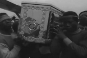 Pallbearers carrying the casket of Robert Mensah