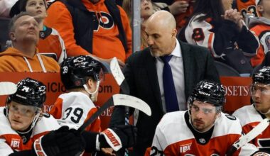 Flyers head coach Rick Tocchet talks to Flyers right wing Matvei Michkov during Thursday's game against the Ottawa Senators.