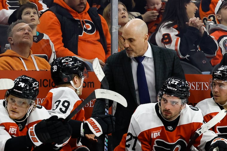 Flyers head coach Rick Tocchet talks to Flyers right wing Matvei Michkov during Thursday's game against the Ottawa Senators.