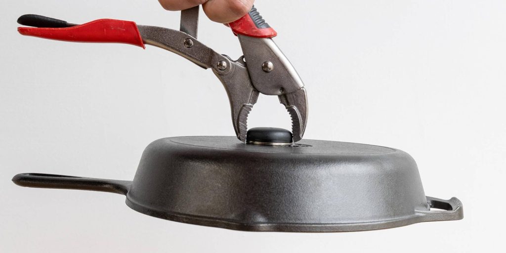 A hand holding a pliers