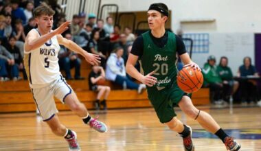 Port Angeles Ashton Gedelman brings the ball up the court against the defense of Sequims Mason Rapelje. Port Angeles won the loser-out District 3 tournament game in Sequim on Thursday 56-45. (Diamond Gentile/for Peninsula Daily News)
